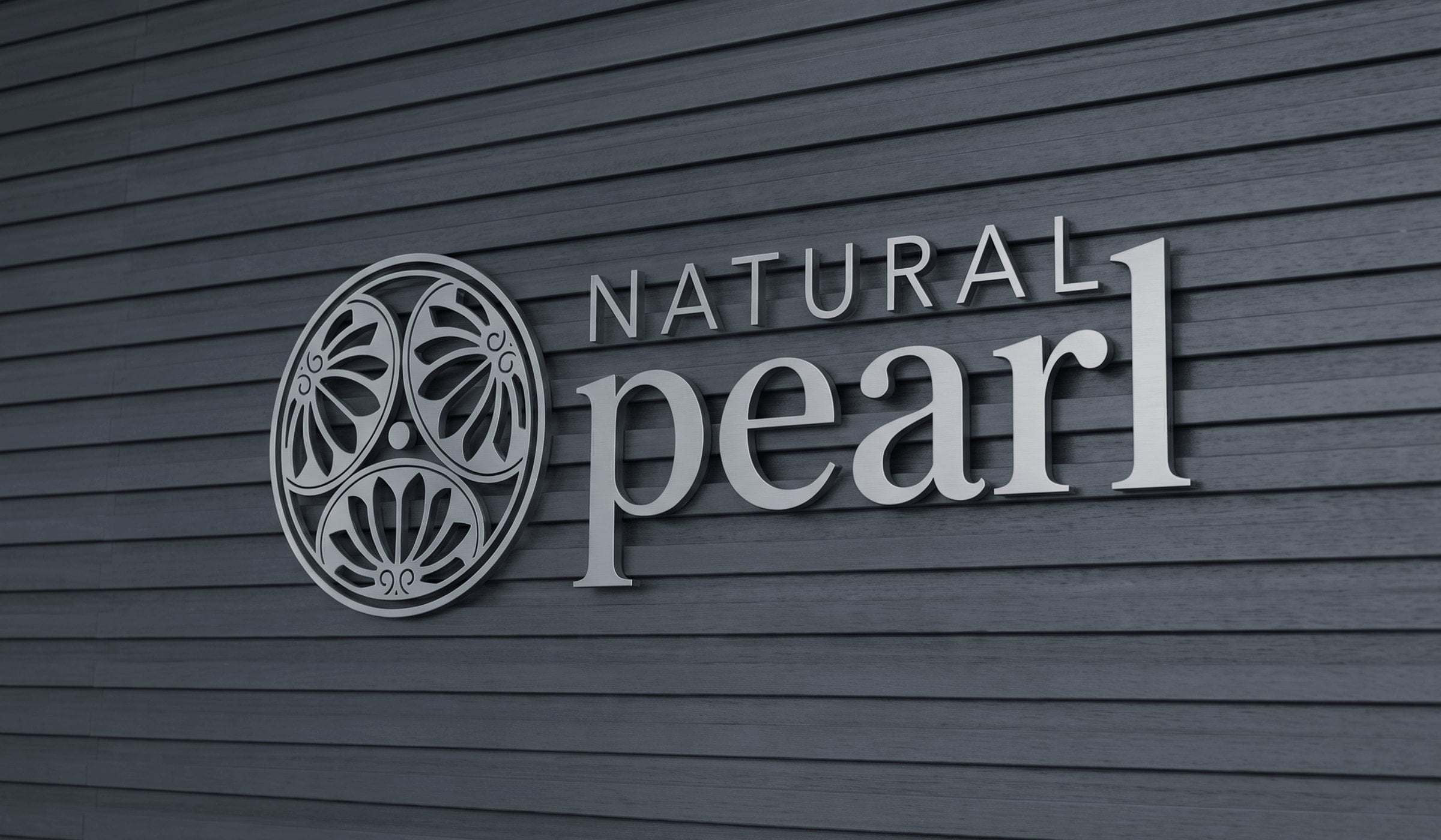 Natural Pearl brushed-steel signage on wood